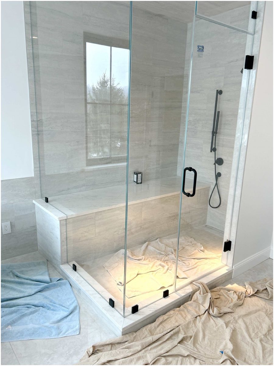 Frameless glass shower door installation with matte black hardware by Shelf in Newburgh NY